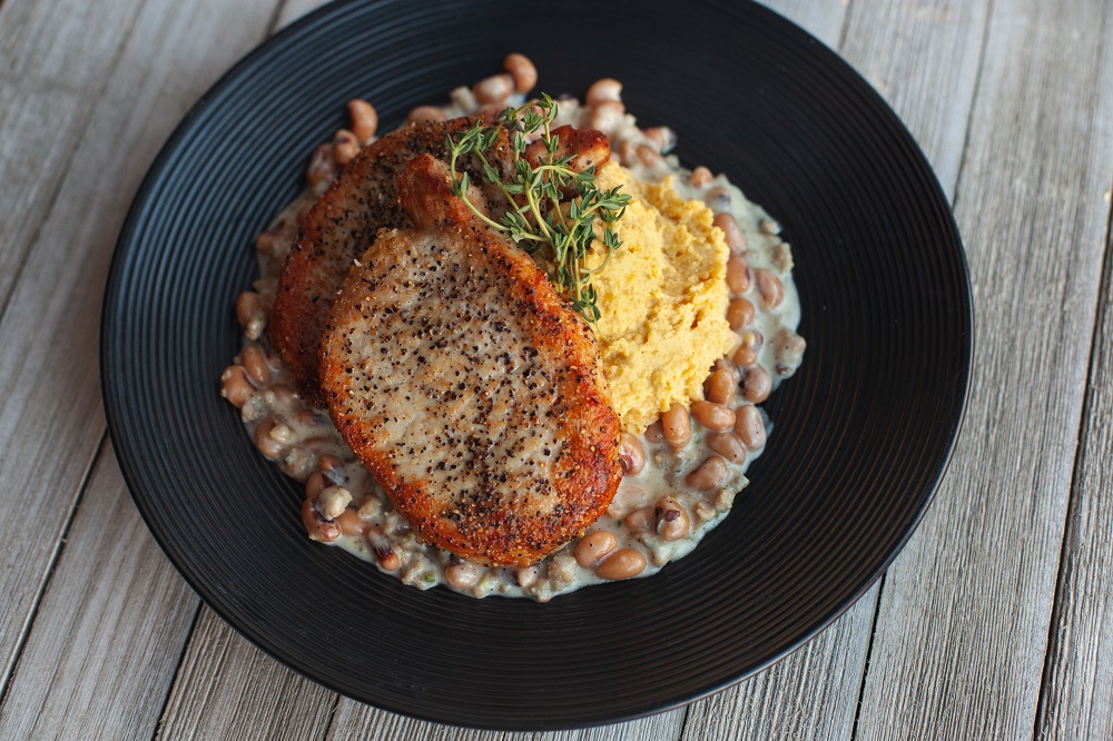 Pork Chops with Smashed Yellow Peas & Black Eyed Pea Gravy