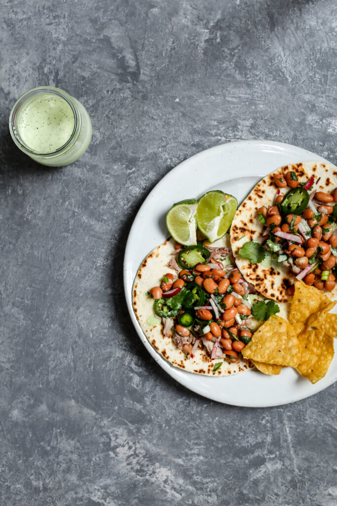 Pork Tacos with Pinto Bean radishes Salad and Cilantro Crema