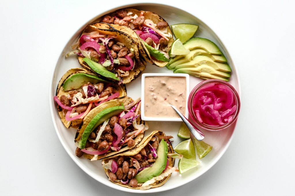 Smashed Pinto Bean Tacos with Pickled Red Onions & Smoky Chipotle Crema Slaw